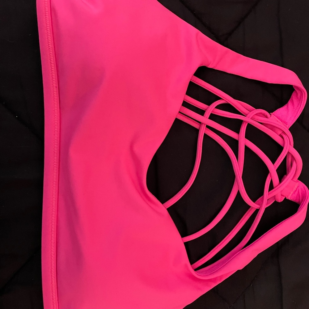 Lululemon Neon Pink Sports Bra size 8 never worn. Free to be bra.